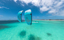 Rider riding the Duotone Evo D/LAB 2027 over a turquoise tropical lagoon