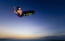 Reno Romeu riding with the Duotone Evo SLS 2027 over the sea at dusk