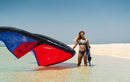 Rider with the 6 m Duotone Evo SLS 2027 on a tropical beach, same model as the Concept Blue