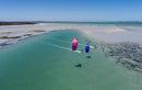Vista aérea de riders com kites Duotone Juice 2026 numa lagoa costeira