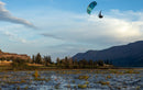 Rider jumping over the river with the Duotone Rebel D/LAB 2026 kite and mountains behind