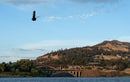 Rider jumping high with the Duotone Rebel D/LAB 2026 kite over the river, with a bridge and hills behind in Hood River