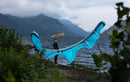Rider setting up the Duotone Rebel D/LAB 2026 kite on the shore of a mountain lake