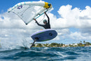 Rider saltando con la tabla y el Duotone Unit SLS Concept Blue 2027 junto a una isla