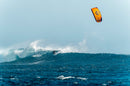 North Carve Orange kite flying over a breaking wave out at sea