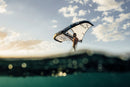 Rider with the North Nova Pro 2026 wing at sunset, water-level view
